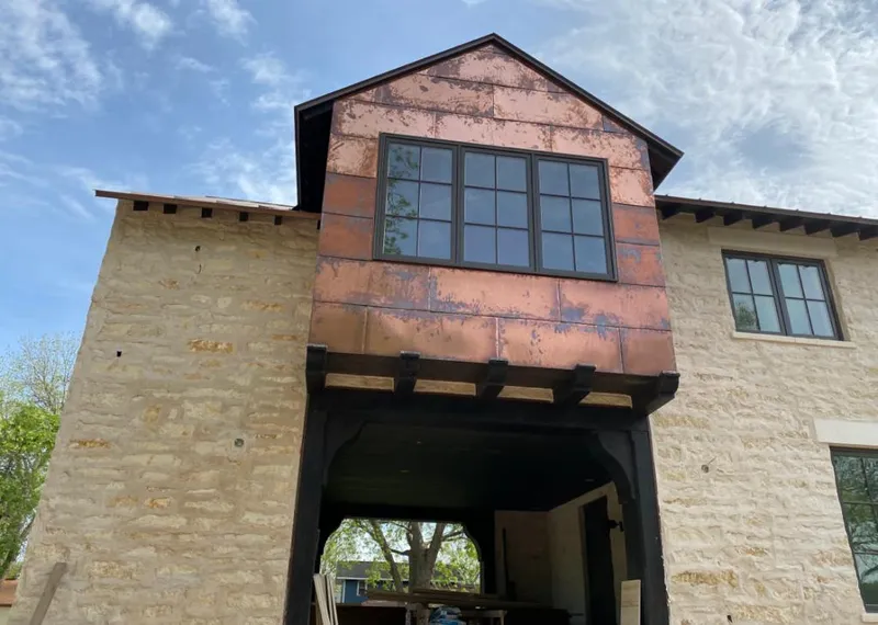 Copper metal panel facade on a stone building for Skylight Installation in Pinehurst